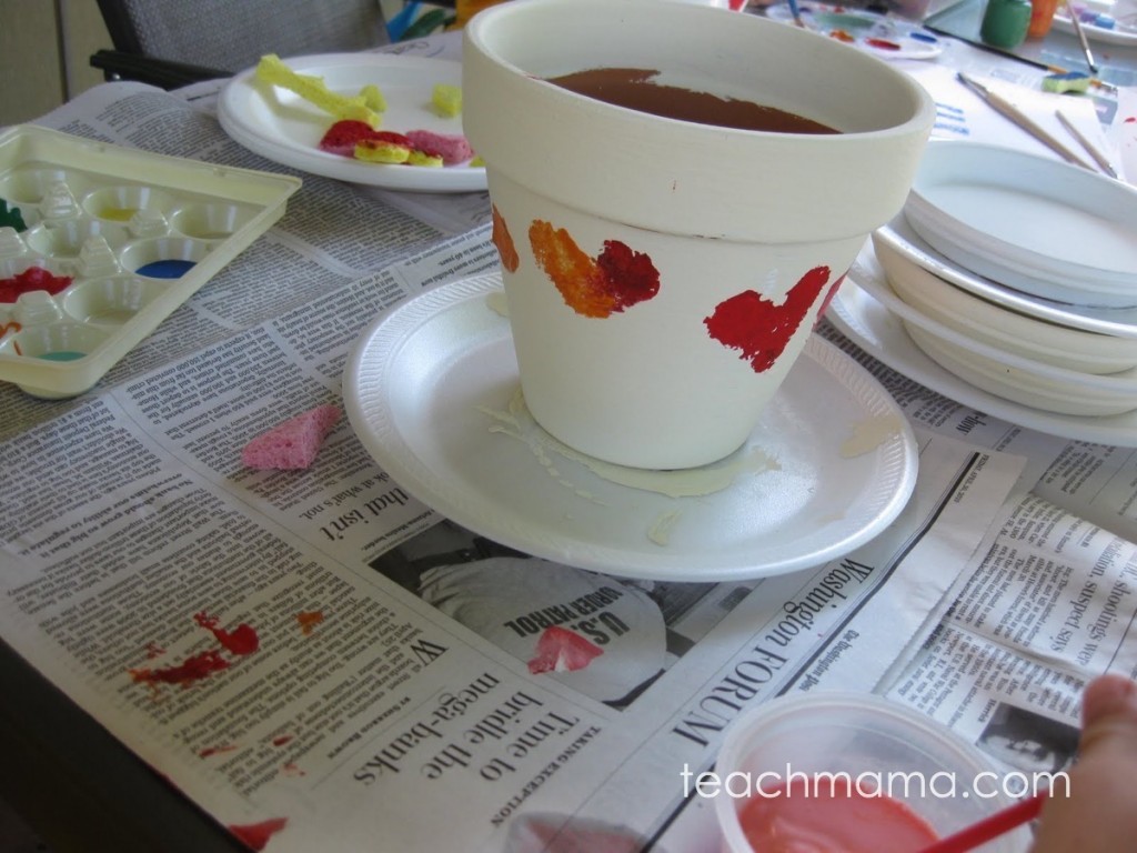 white flower pot with red hearts painted on