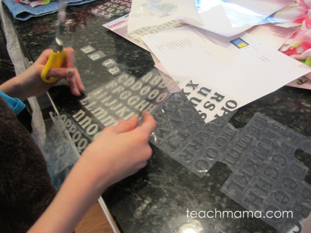 girl cutting iron-on letters out