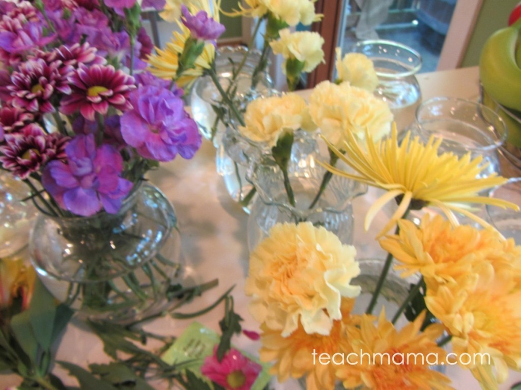 various flowers in vases on counter