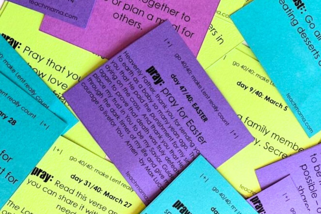 Lent cards for christian families printed in various colors and cut out for use - scattered across a table top