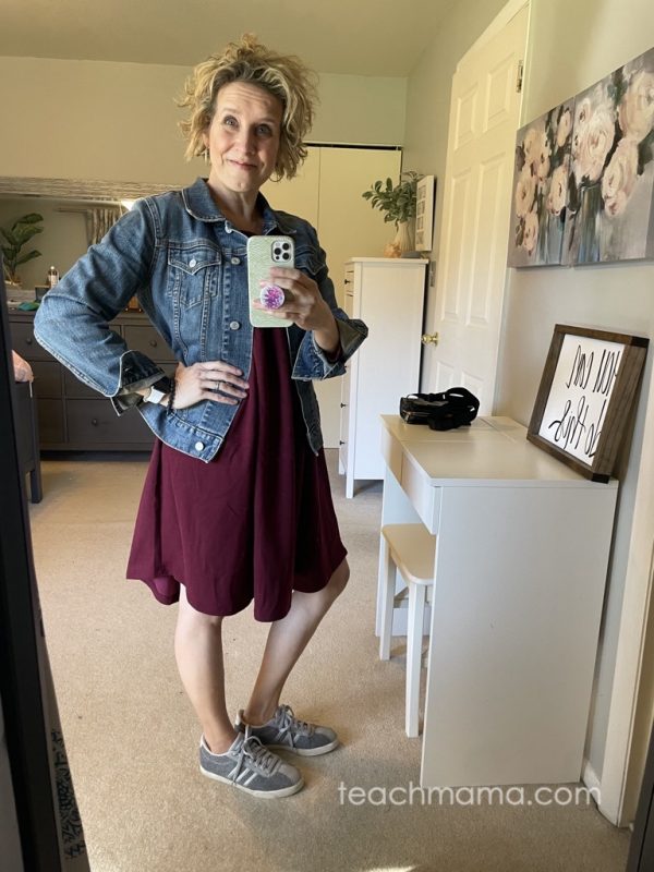 woman in burgandy dress with jean jacket and sneakers