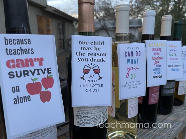 wine bottles on a porch with gift tags on them