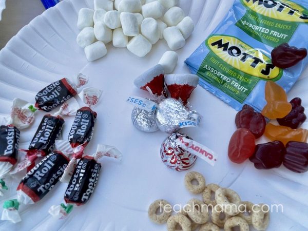 tootsie rolls, marshmallows, fruit snacks, and cheerios on a white plate