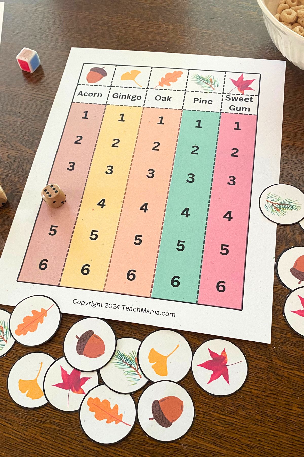 fun fall grid games for math and literacy learning Printed Game Board with five columns. Brown, yellow, orange, green and red with printed leavers at the top, a wooden die and printed leaf game markers.