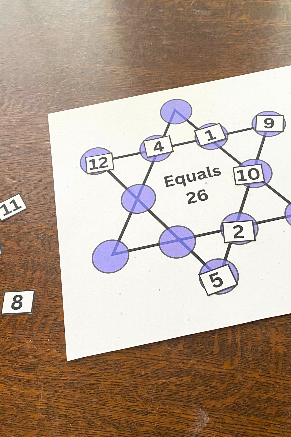 Six-pointed star with purple circles at each corner and line intersection. Printed numerals are arranged around two sides to equal twenty-six