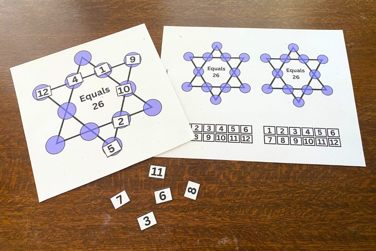 One sheet with a six-pointed star with purple circles at each corner and line intersection. Printed numerals are arranged around two sides to equal twenty-six. Second sheet with two starts and numerals beside it.