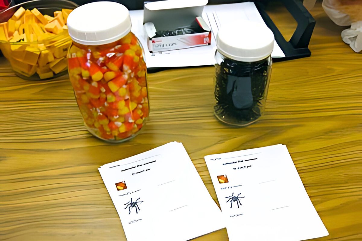 spooky halloween treats, class party help for classroom parents One jar filled with candy corn and another filled with plastic spiders for estimating quantities