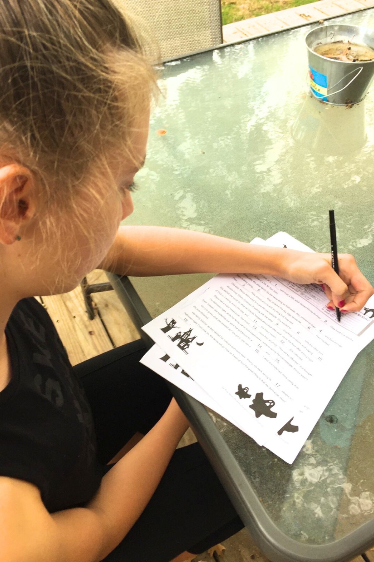 Older girl working the Halloween Mad-lib worksheet