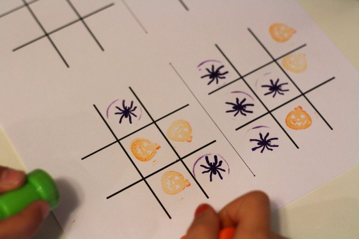 Tic-Tac-Toe board with pumpkin and spider stamps
