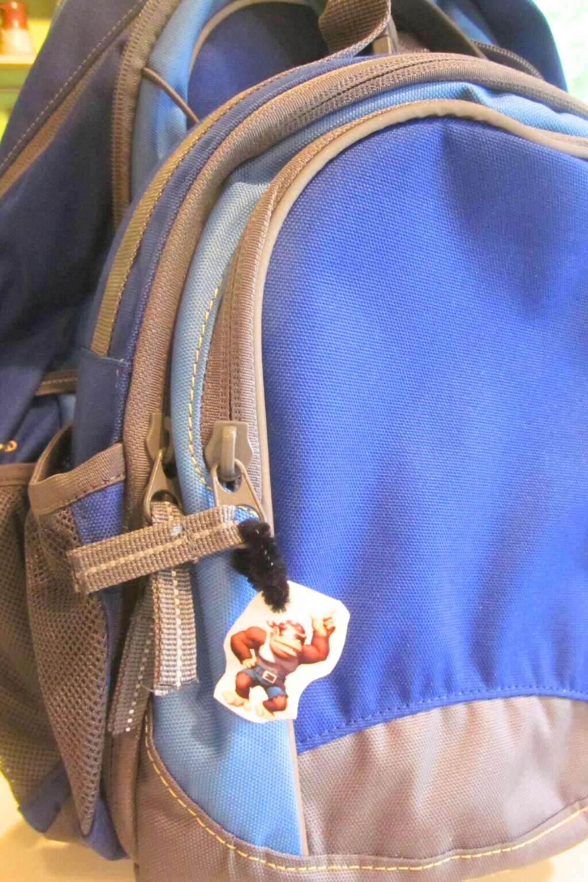 shrinky dink backpack bling 21 Blue backpack with a shrinky-dink tag on the zipper pull
