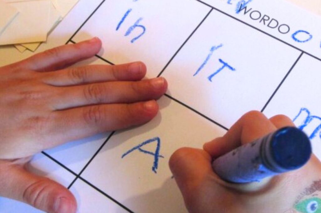 wordo sight words 2 Child's hand writing words on a grid sheet
