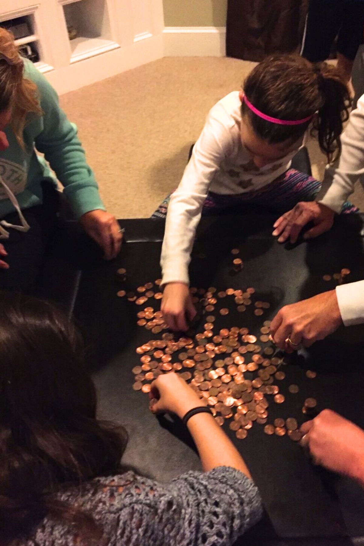 Children around a table stacking pennies
