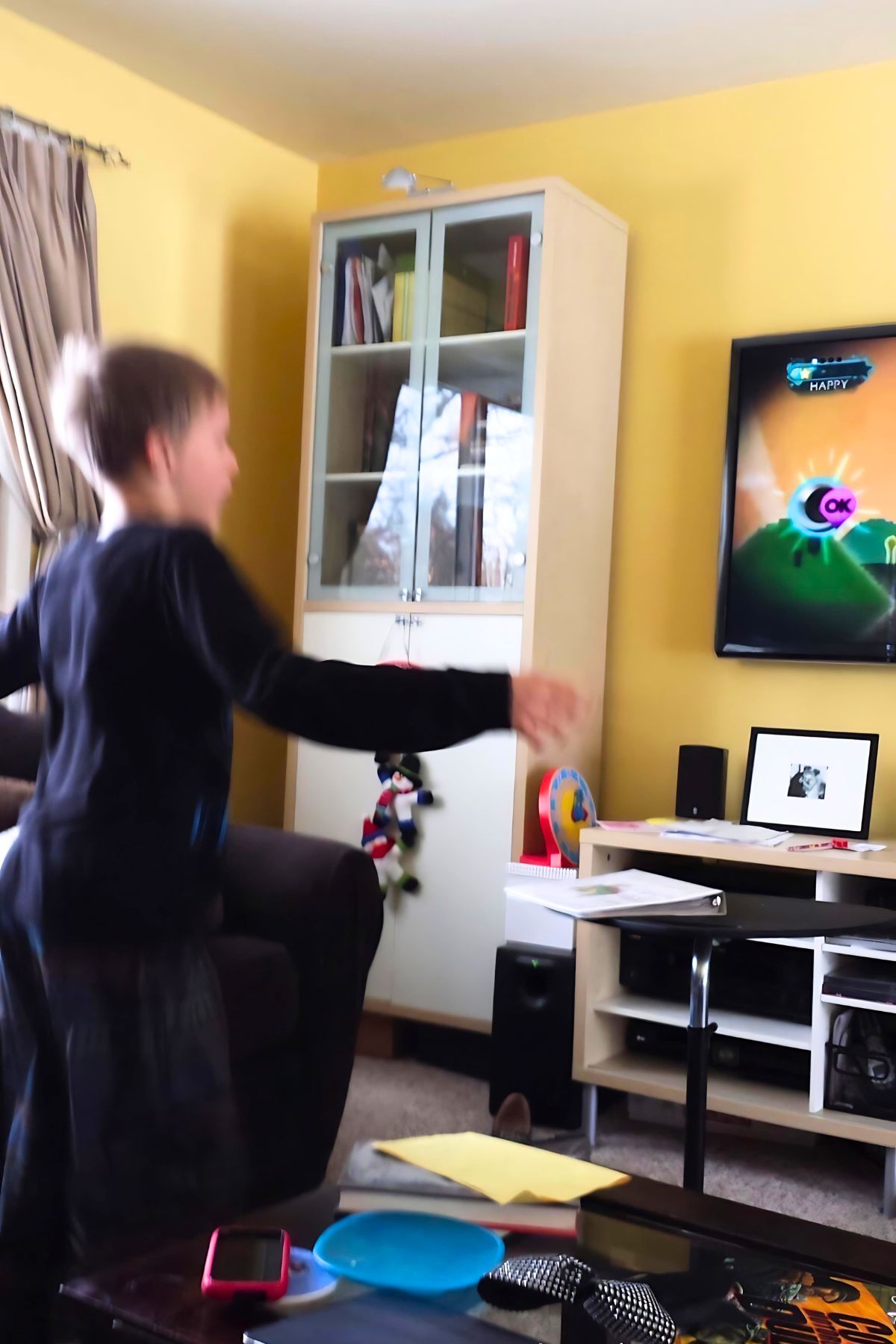 Boy dancing in front of a television to a children's dance video