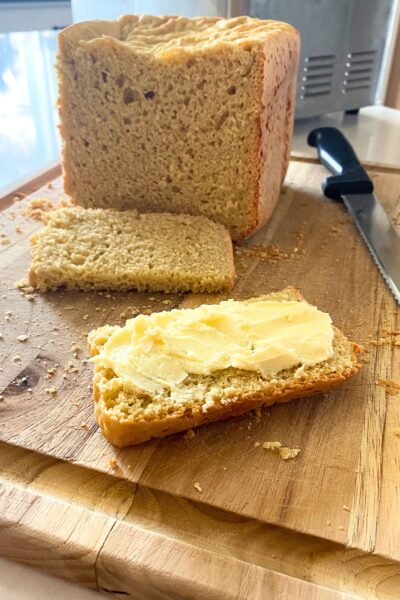 Homemade bread with butter on a wooden cutting baord