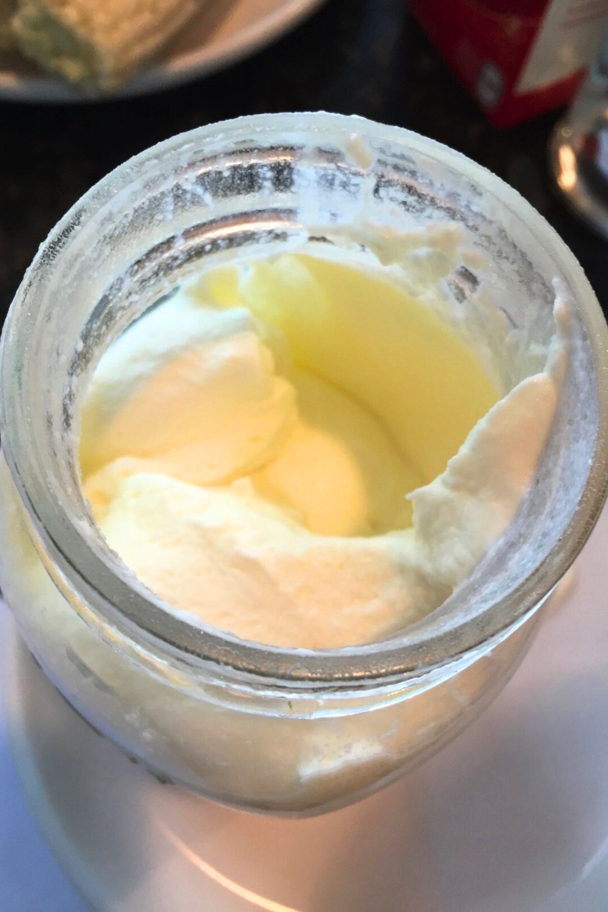 Freshly churned butter still in the glass jar
