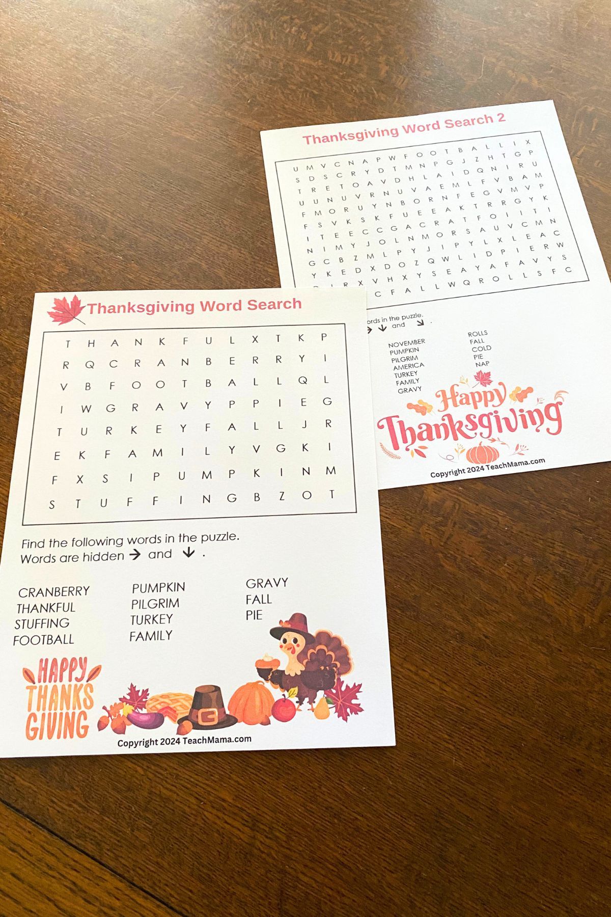 Thanksgiving-themed word search sheets on a wooden table