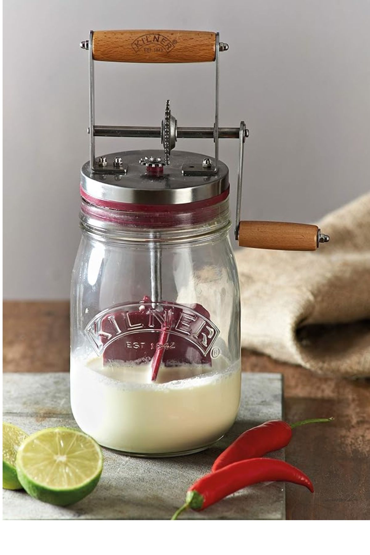 Quart glass jar and lid with a wooden crank handle and plastic dasher inside the jar