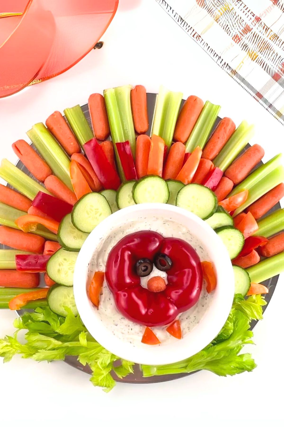Brightly colored veggies arranged to form the image of a turkey on a platter