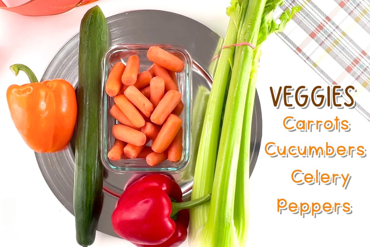 vegetables needed to make a turkey veggie platter tray, including carrots, cucumbers, celery, and peppers