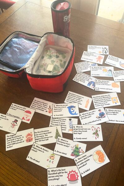 Lunchbox notes on a wooden table next to a red lunch pail