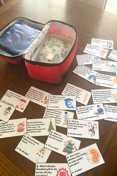 Holiday Fun Fact Lunchbox notes on a wooden table next to a red lunch pail