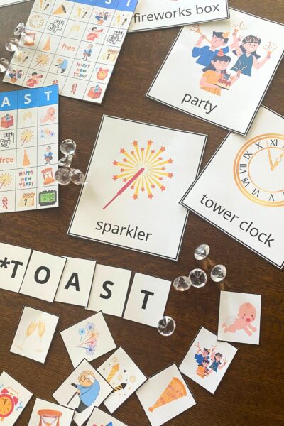 Colorful New Year themed bingo playing boards and cards on a wooden table
