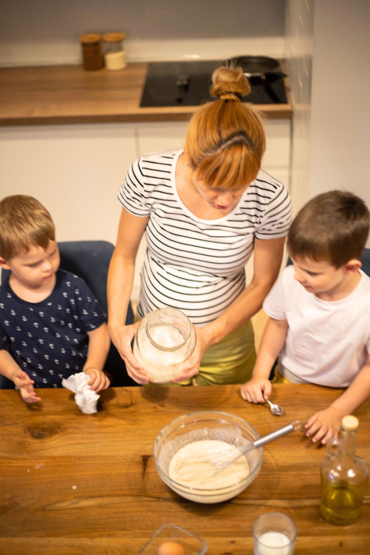Mom and two boys experimenting with pancake batter