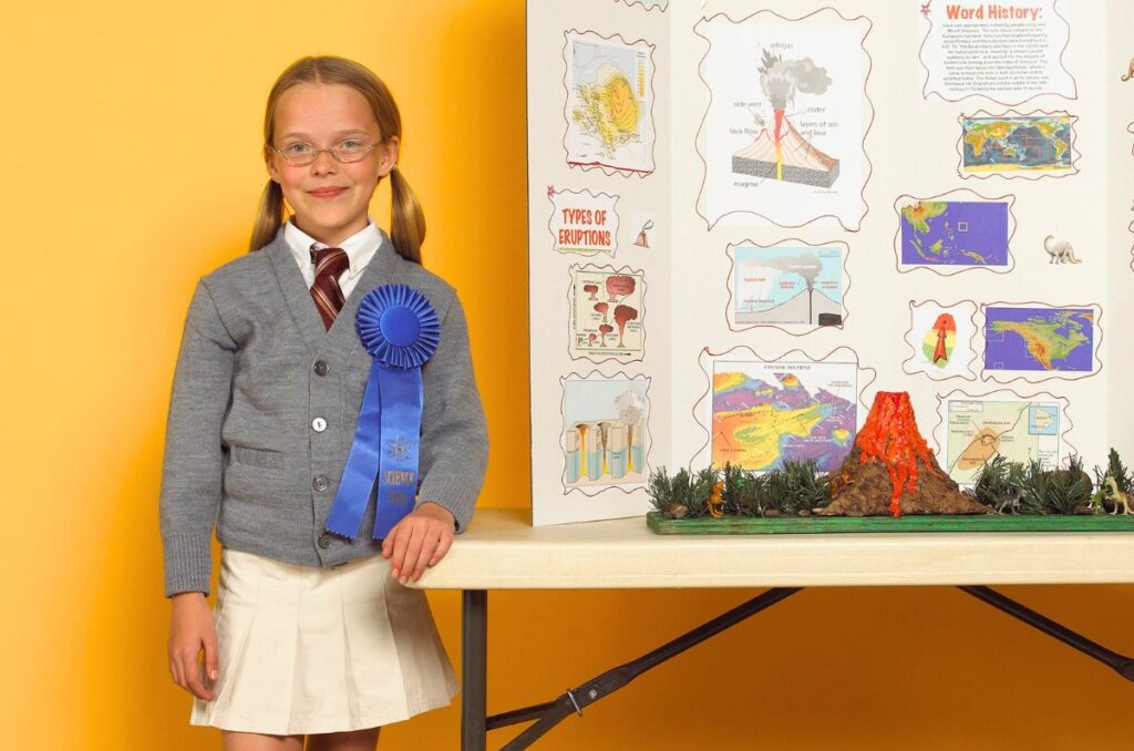 Young girl standing in front of a science fair project