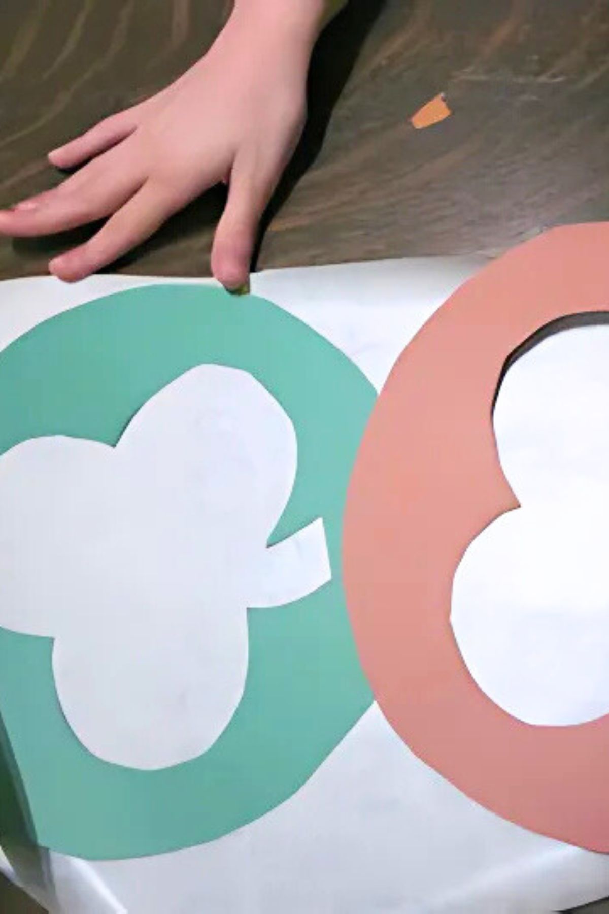 Two shamrock shapes cut from green and brown construction paper.