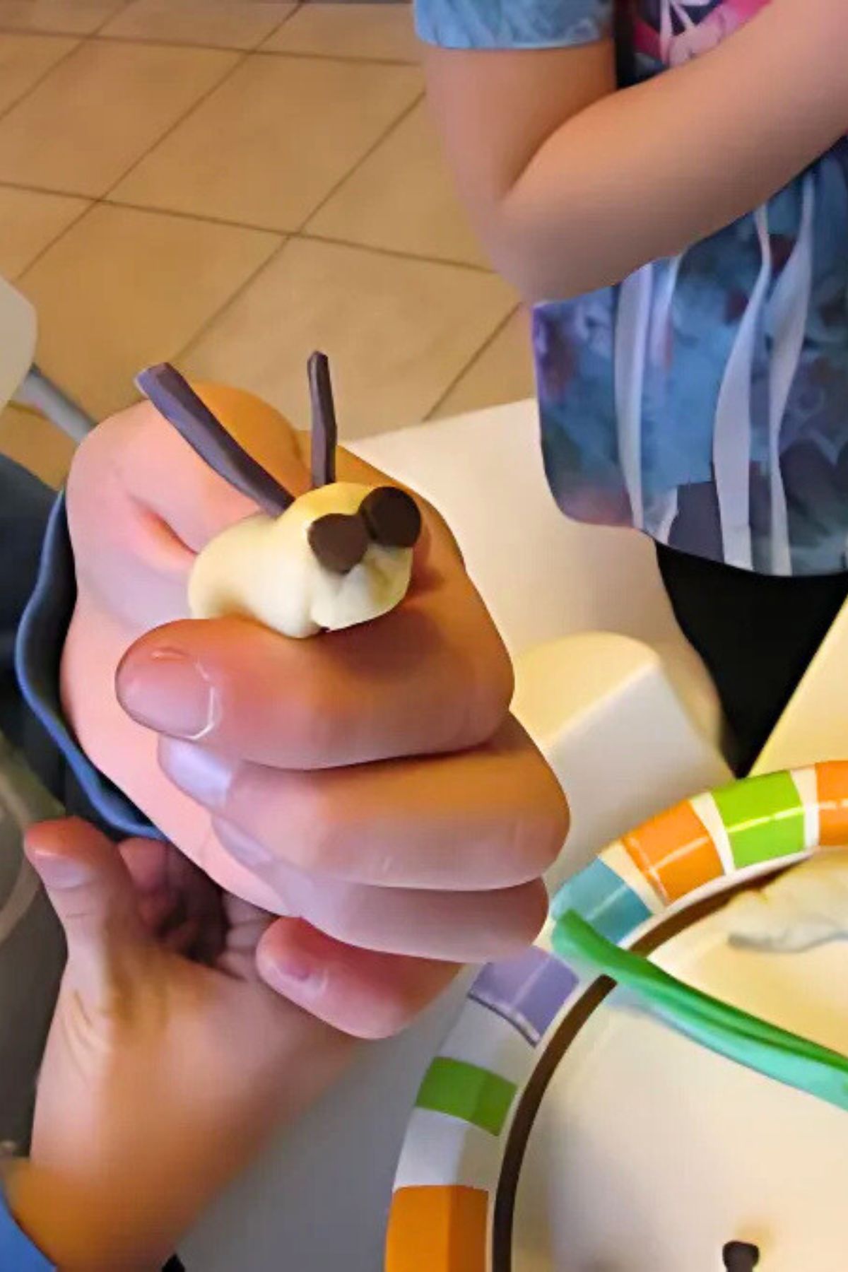 Hand forming a candy caterpillar