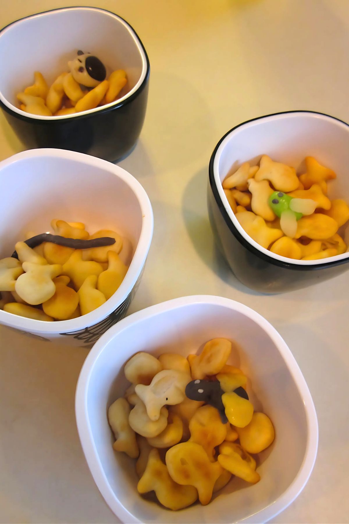 Candy bugs in bowls of Goldfish snack crackers