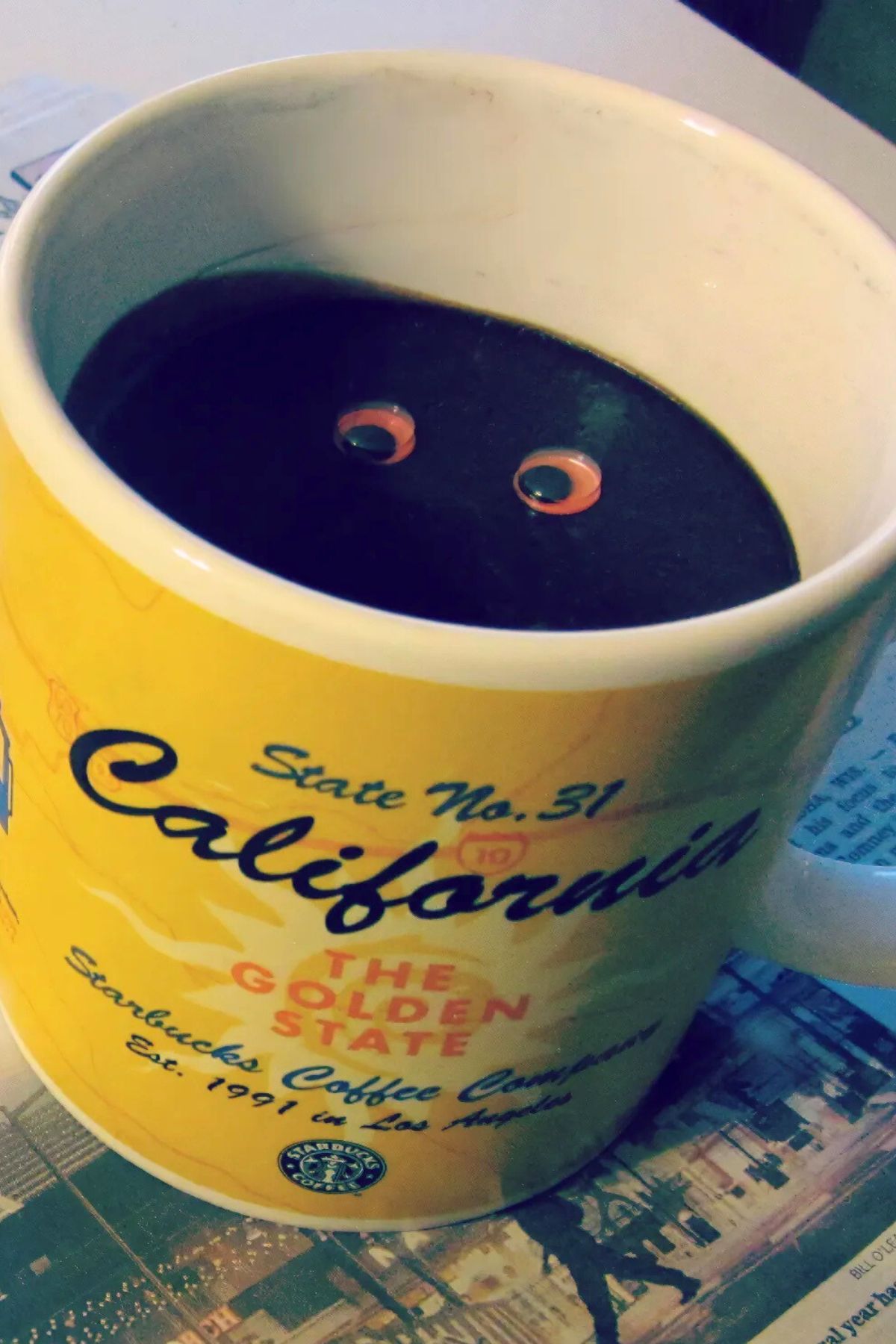 Coffee mug with chocolate jello instead of coffee and a pair of googly eyes