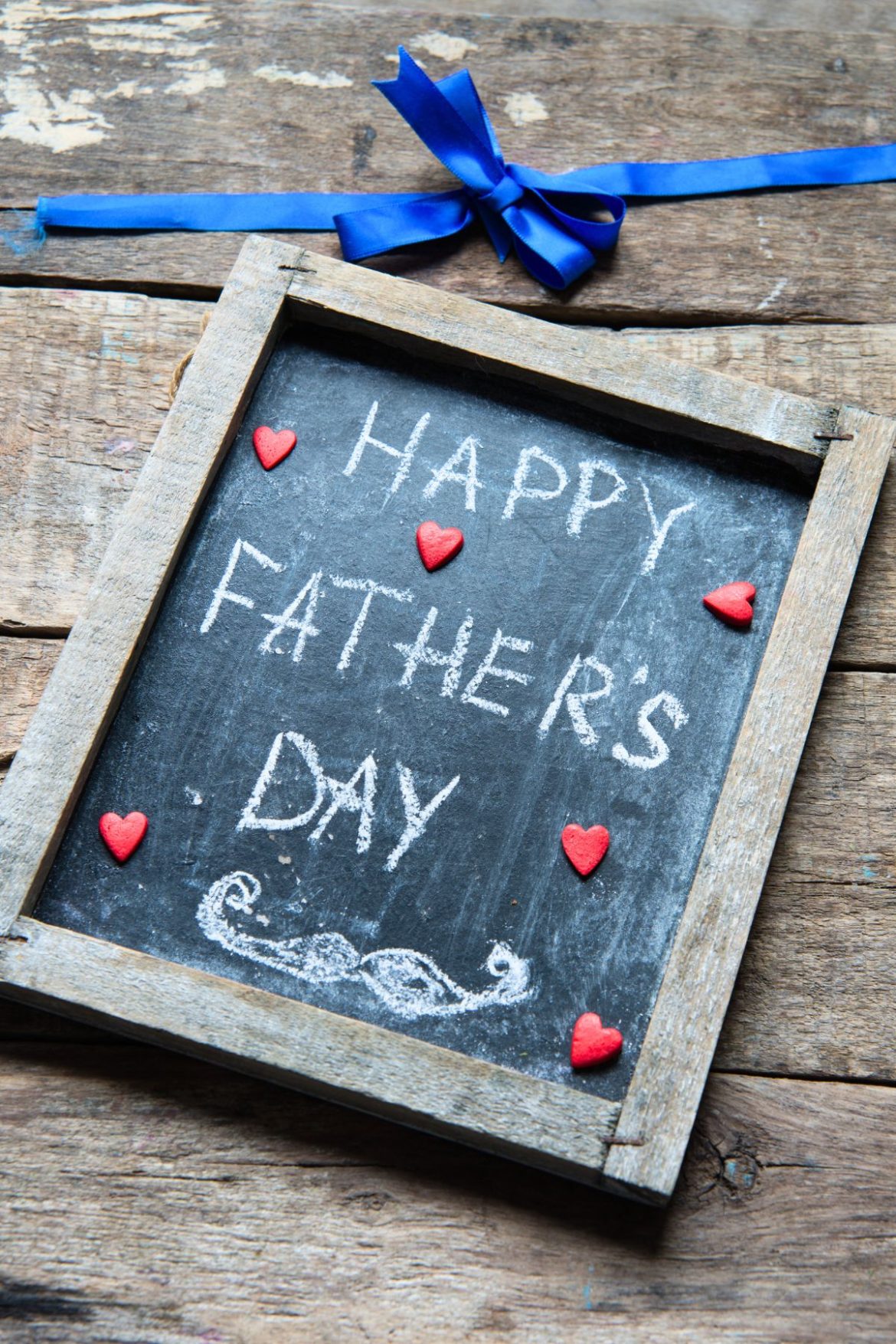 Happy Father's Day written in chalk on a small chalkboard with a wooden frame