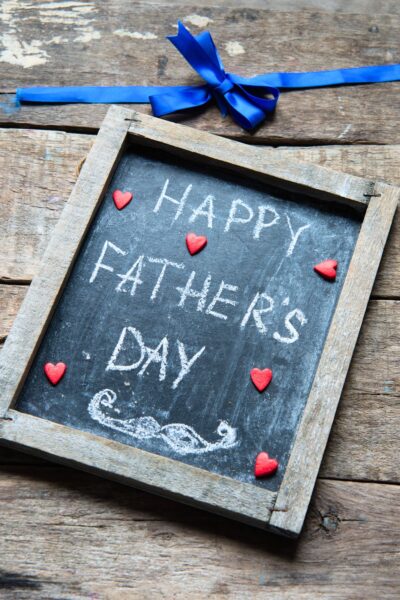 Happy Father's Day written in chalk on a small chalkboard with a wooden frame