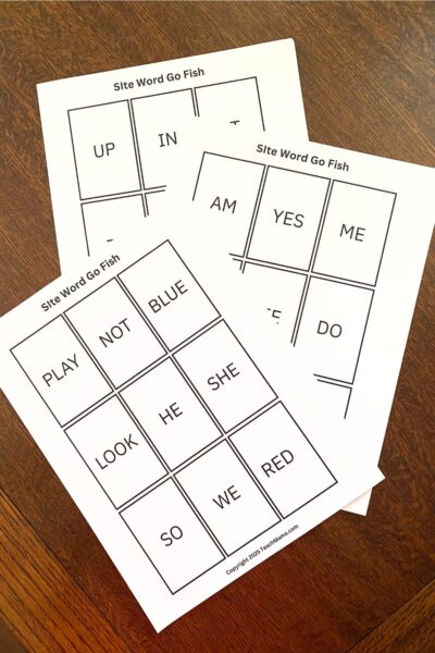 Sight words in playing card-sized squares printed on white card stock on a wooden table