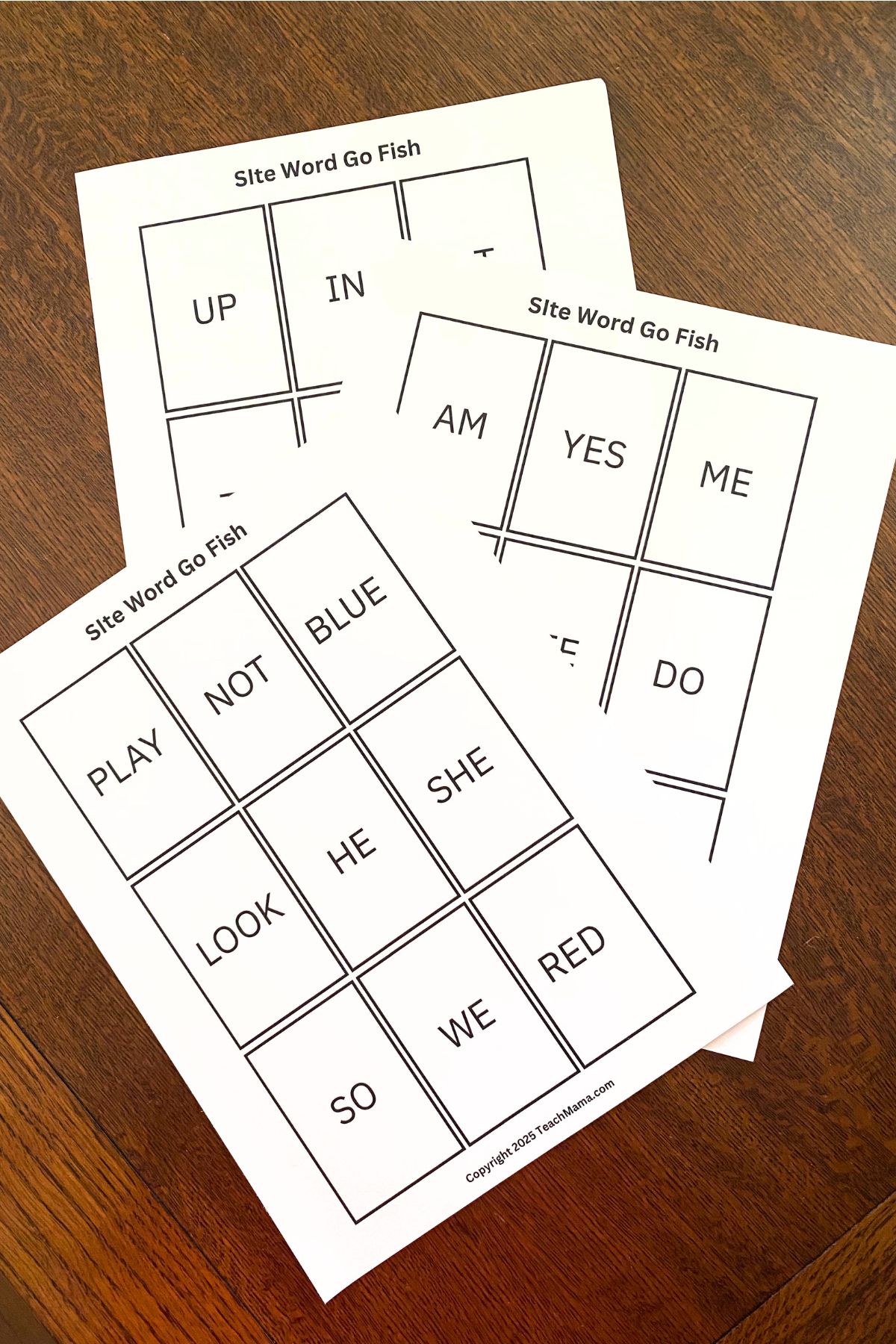 Sight words in playing card-sized squares printed on white card stock on a wooden table
