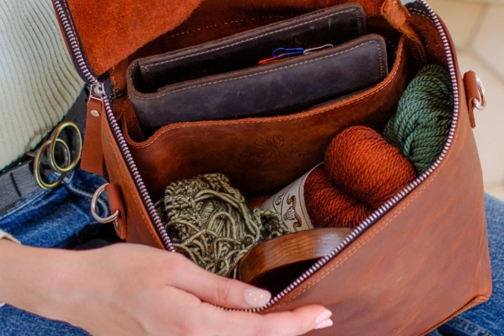 Open leather project bag with yarn skeins