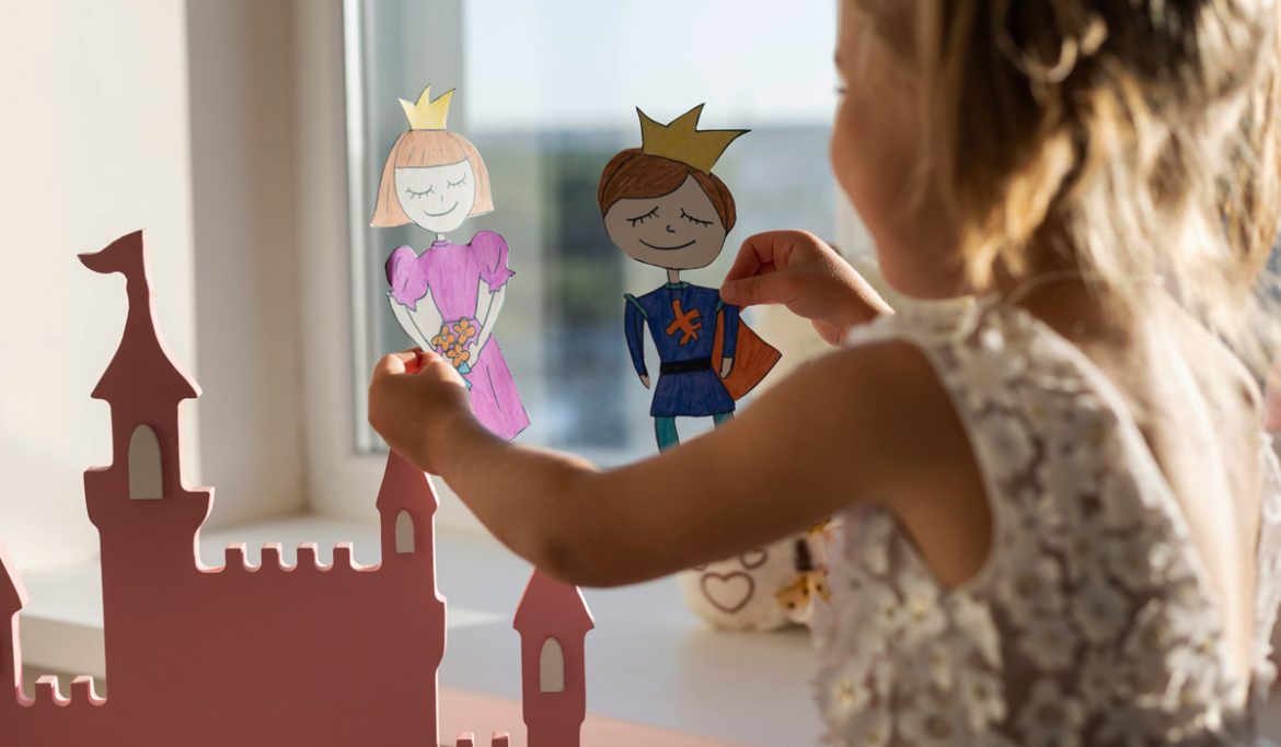 Adorable little girl playing with her puppets 